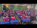 Chinese school children exercising at their desks