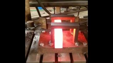 Punching an axe eye on an Anyang press