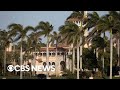 What led to the FBI search warrant at Mar-a-Lago?