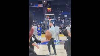 Steph Curry and Luka Doncic engage in a half-court shooting contest prior to the game