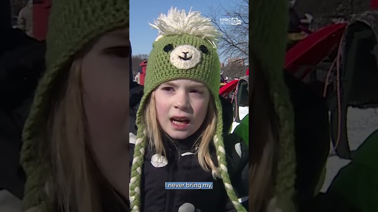 Children in Kansas City's Brookside neighborhood bundle up to go sledding