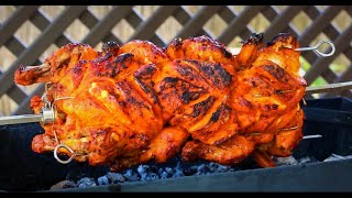 Tandoori chicken on charcoal rotisserie grill