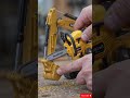 This Tiny Bright Yellow Chainsaw Cuts a Mini Excavator Arm Like a Real Construction Tool Gone Wild