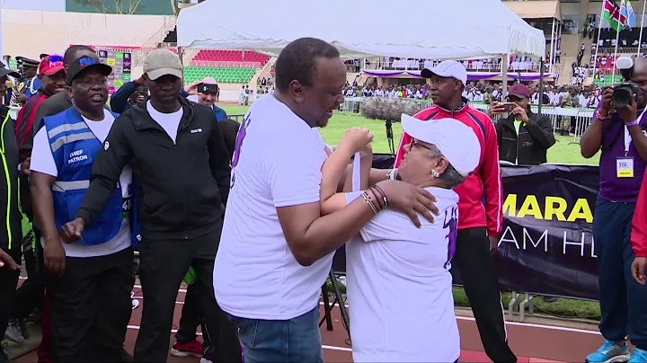 UHURU KISSES HIS WIFE MARGARET AFTER COMPLETING HI...