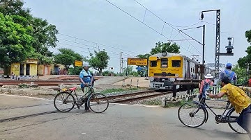 Dangerous situation at Rail Gate careless public crossing rail line casually front of local train