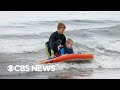 Young surfer teaches others to surf in California