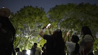 Stargazers, families and astronomers camp outside Caracas planetarium to see partial lunar eclipse