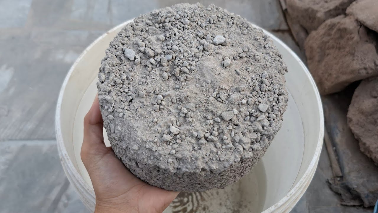 New video Grey gritty  crumbling in water bucket satisfying