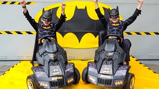 Vlad und Niki geben vor, Batman zu sein und spielen mit Batman-Spielzeug