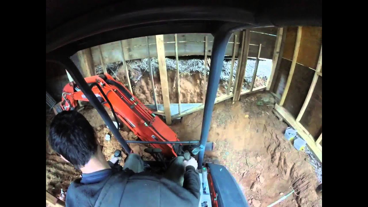 Kubota mini excavator digging out a barn part 1