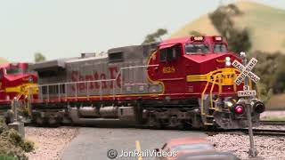 Ho Scale BNSF stack train passes through RR crossing on the California Southern ft. colorful power