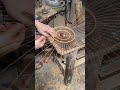 bending some bamboo that has been cut into small pieces that will soon be shaped