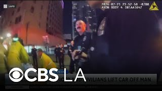 Video shows LAPD officer and civilians lift car to save a person trapped