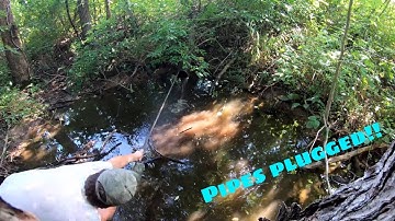 Unclogging the pond drain and moving pumps!