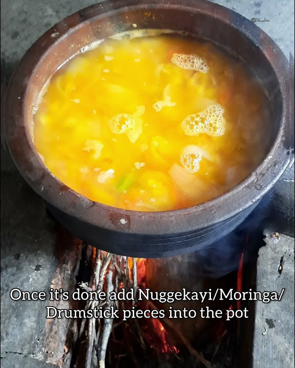 Nuggekayi/Moringa/Drumstick Sambar on Firewood Stove in an earthenware