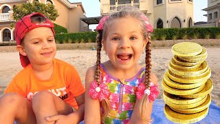 diana and roma play on the beach with dad