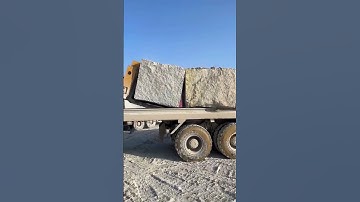 Natural granite blocks are mined and loaded- Good tools and machinery make work easy