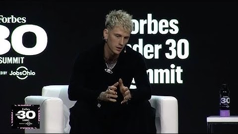 Machine Gun Kelly confronted by fan onstage during interview, security intervenes