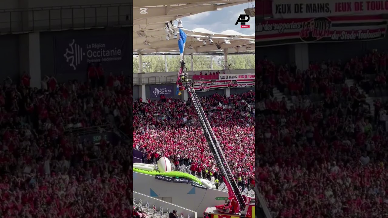 FRANCE: Rugby match delayed after parachutist left dangling from stadium roof