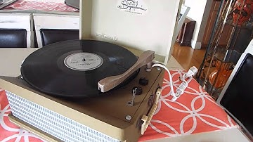 Symphonic manual 4 speed record player playing a 33.3 RPM LP record.