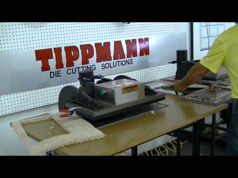 Die cutting machine cutting carpet.  Die cutting press demonstration.