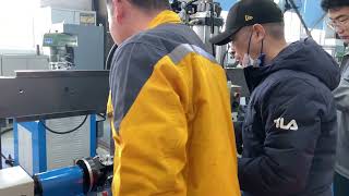 Drive shaft dynamic balancing machine with welding unit