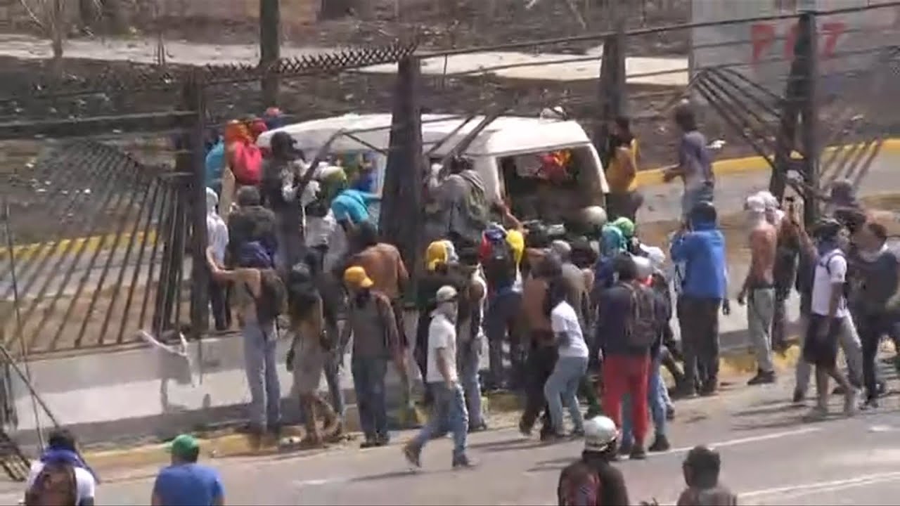 Protesters in Venezuela set van on fire on military air base