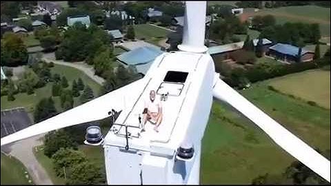 Benedictine Monk Relaxing atop Wind Turbine Spotted by Drone