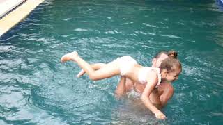 Happy family, active father with little child, adorable toddler daughter, having fun in swimming