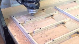 Cribbage board jig Custom jig holds 27 boards, which are held in place by a hand operated cam.