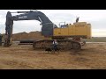 Diging with an John Deere 870G Excavator.