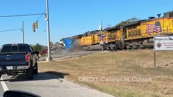 CAUGHT ON CAMERA | Train collides with 18-wheeler hauling cars