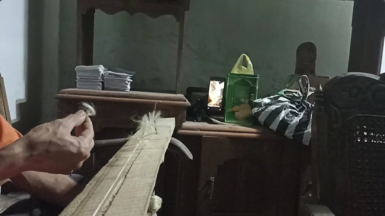 Weaving synthetics into Rangda's hair 