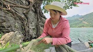 The girl made a giant racket on the boat to scoop fish.