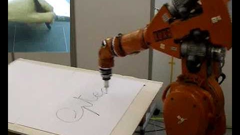 An industrial robot carrying out a writing task