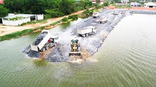 SDLG Wheel Loader is transferring stones to a large lake to construct a new road 10 wheel dump truck