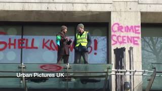 Climate change activists smash windows at Shell's London HQ