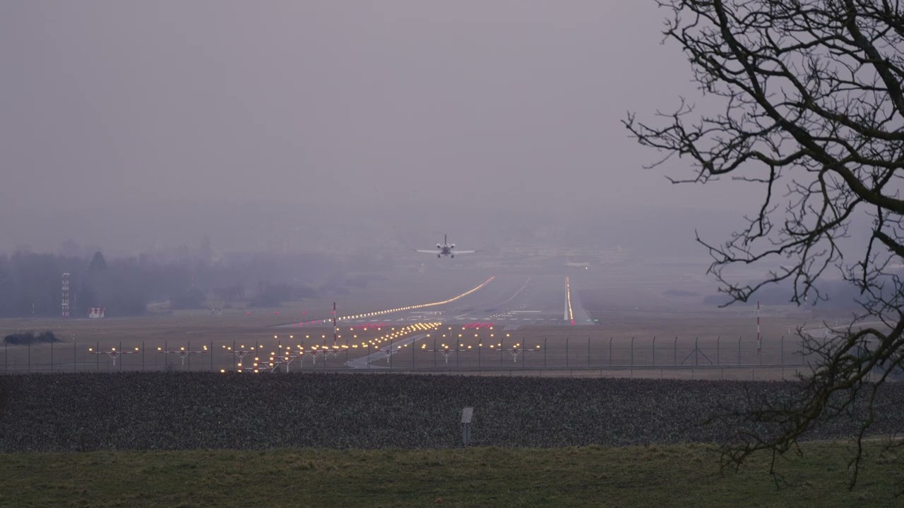 Zurich Airport Flexjet private jet Embraer Praetor 600 9H-IFX landing on a foggy winter day.