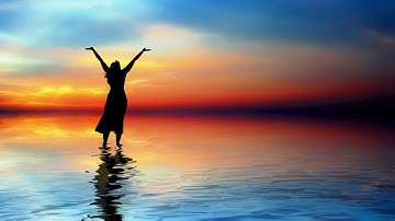 Woman In Praise Under Beautiful Skyline Standing In Ocean Water 4K Christian Worship Motion Loop