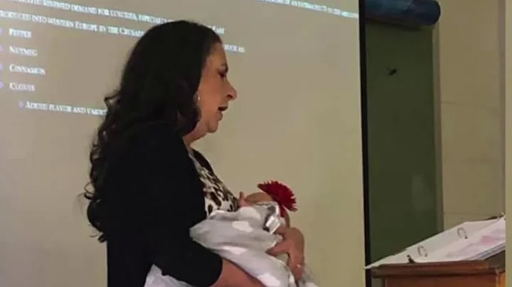 Professor holds baby for student in class
