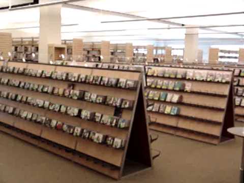 This is a video of the First floor of the new Laramie County Library. The first floor houses the fiction, science fiction books along with Movies, Books on CD, video games, and music CDs. The newspapers and magazines are also on this floor. There is also a large meeting room and Synergy cafe. Some Highlights: 00:00 ~ Looking East along the main entranceway. 00:06 ~ A meeting room with a stage. 00:23 ~ Self-checkout/book drop/circulation desk. 00:33 ~ Greeter desk (foreground), reader's advisory desk (background), and fiction book stacks. 00:47 ~ Music/video/video game collection. ====================== To see a floorplan of this level, go to: picasaweb.google.com In this picture: The top is East, the bottom West, the left North, and the right South. The East half of the library is the patron side where books/services are. The West half is for staff use only.