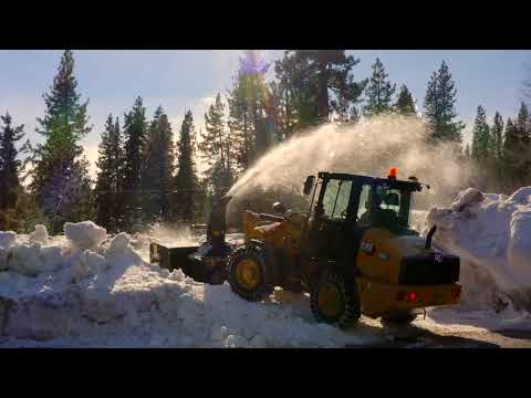 Cat® 906 Next Generation Compact Wheel Loader Removing Snow