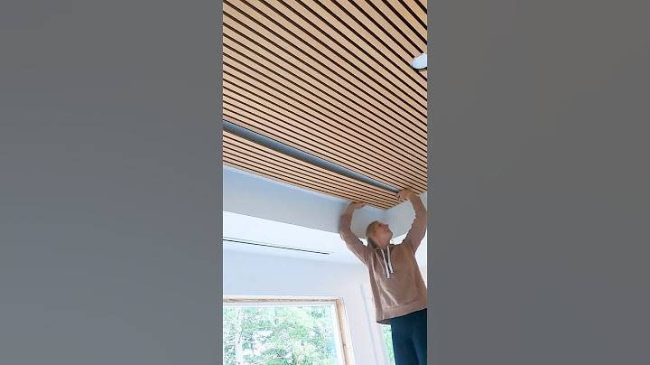 Installing acoustic slat panels on a ceiling. #slatwall #interiordesign #diy