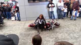 woman teaches how to tip up a Harley alone