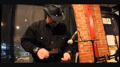 Chris Lockett playing slit drum at Cafe Muse