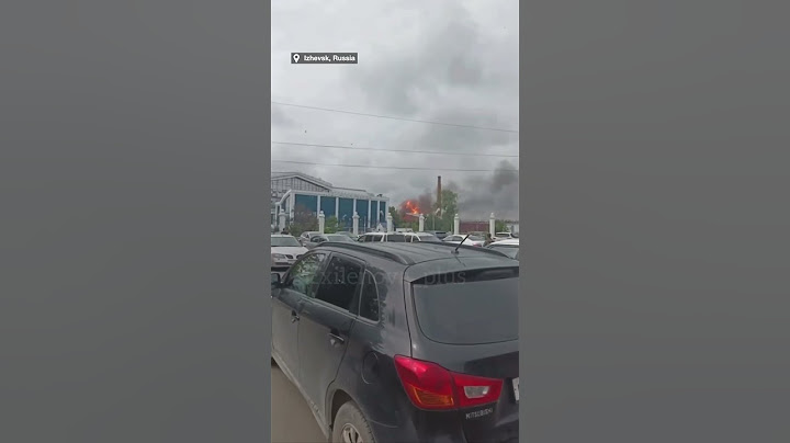 Pedestrians run as Ukraine drones strike Russian military plant