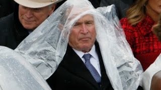George W. Bush struggles with his poncho at Trump's inauguration