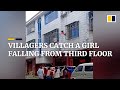Quick-thinking villagers catch a girl falling from third floor of a building in China