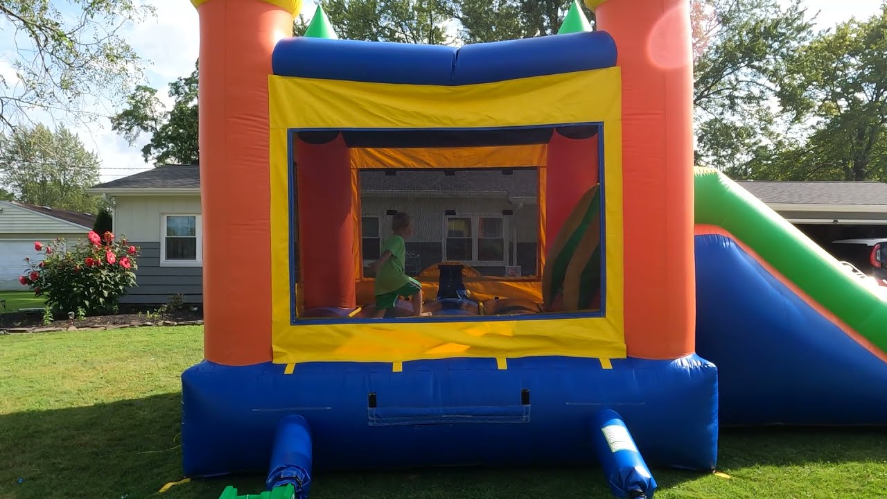 POV rolling and wiping down bounce house combo