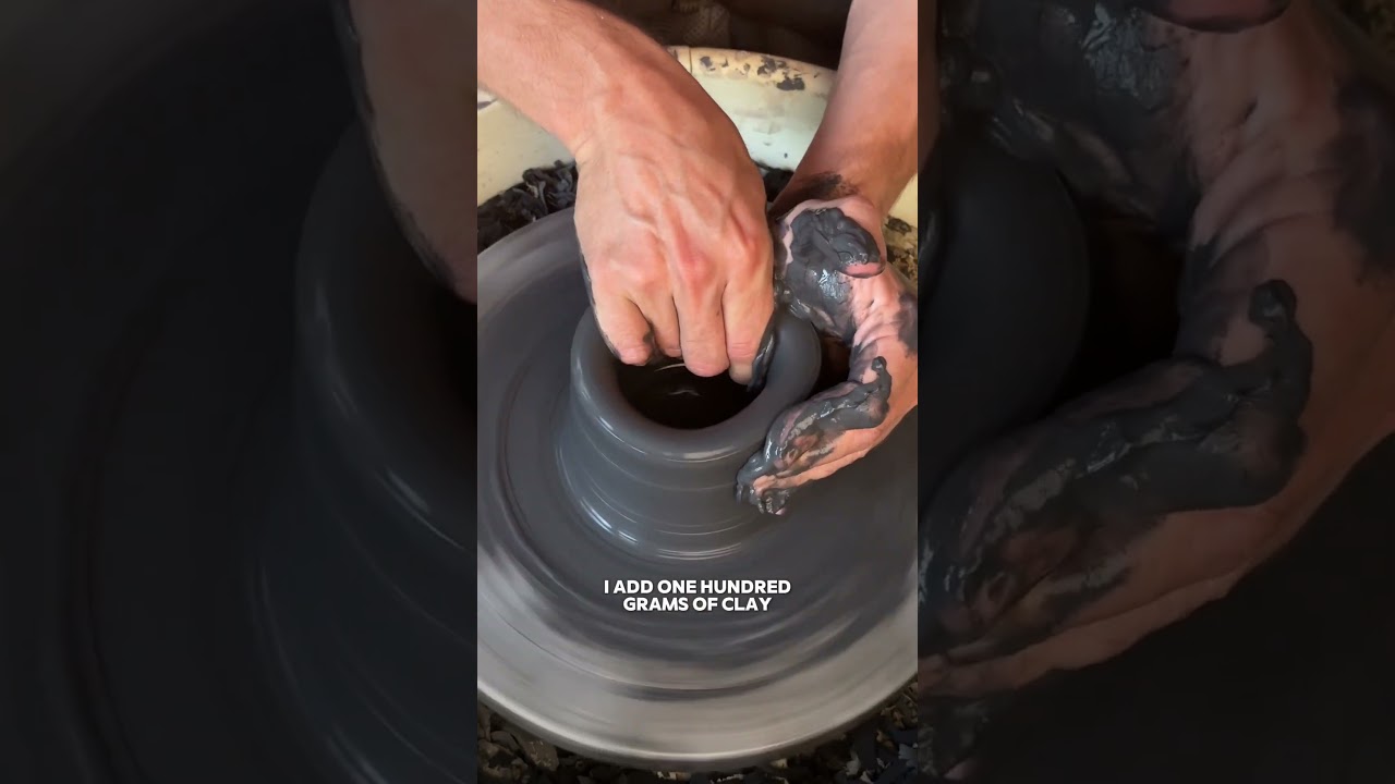 Video thumbnail of a potter shaping a dark clay form on the wheel